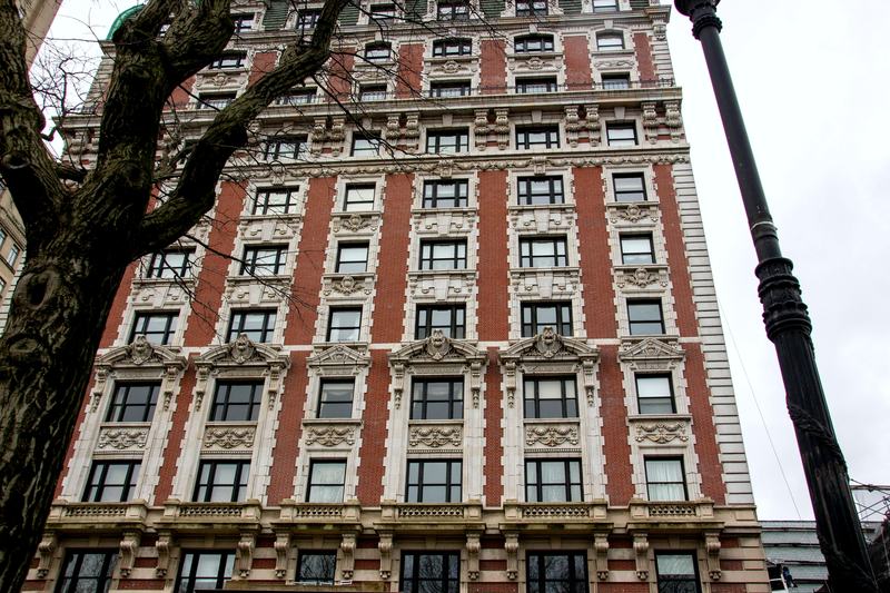 A prewar Upper West Side apartment building, terracotta cornice against the sky
